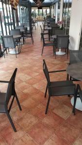 a room with tables and chairs on a tile floor at Hotel Venezia in Caorle