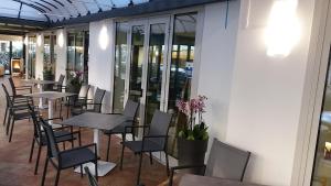 a row of tables and chairs in a restaurant at Hotel Venezia in Caorle