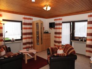 a living room with two chairs and a table at Gästehaus Vogl in Bodenmais