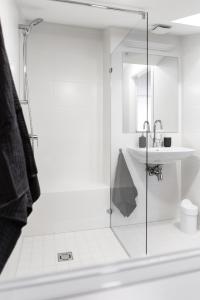 a bathroom with a glass shower and a sink at Deluxe Apartments by Hostlovers in Kaunas +45 photos