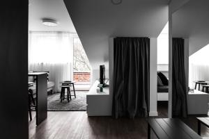 a living room with a bed and a dining room at Deluxe Apartments by Hostlovers in Kaunas