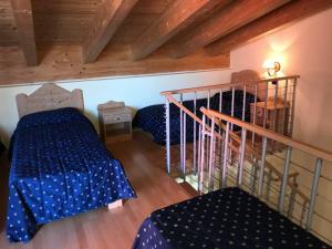 a attic room with two beds and a staircase at Hotel Sole del Baldo in Brentonico