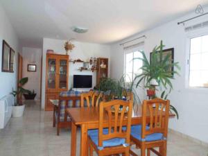 a dining room with a wooden table and chairs at Can Vich in Santanyi