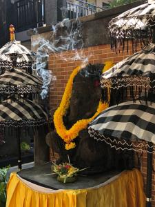 a stage with a table with yellow flowers on it at Tirta Yoga Inn in Padangbai
