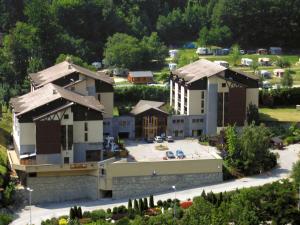 an aerial view of a building with a parking lot at Residence Cybele "Grand Confort" in Brides-les-Bains