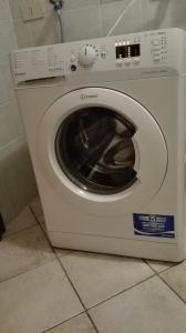 a white washing machine sitting in a kitchen at Pinzolocasa in Pinzolo