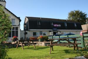 a couple of benches in front of a building at The Albert Inn in Nairn