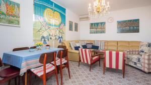 a living room with a table and chairs and a couch at Villa Amalia in Murter