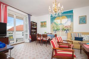a living room with a couch and a table with chairs at Villa Amalia in Murter