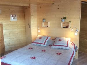 バルジョルにあるCabane des K'Hauts Pinsの木造キャビン内のベッド1台が備わるベッドルーム1室を利用します。