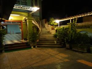 a staircase leading up to a building at night at Backpackers Hotel in Hà Tĩnh