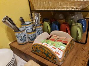 a shelf with dishes and utensils in a kitchen at Agriturismo Rivieraoglio in Piadena