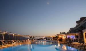 a pool at a resort with a bridge at Aegialis Hotel & Spa in Aegiali