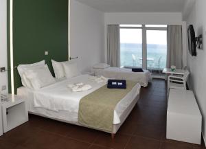 A bed or beds in a room at Erytha Hotel & Resort Chios