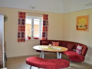 a living room with a table and two chairs at Ferienhof Nirschl in Winzer