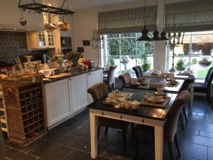 a kitchen with a table and chairs and a counter at Casa Romantico in Bruges
