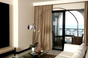 a living room with a couch and a balcony at Dar El Marsa Hotel & Spa in La Marsa