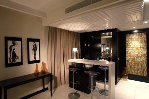 a living room with a bar with stools in it at Dar El Marsa Hotel & Spa in La Marsa