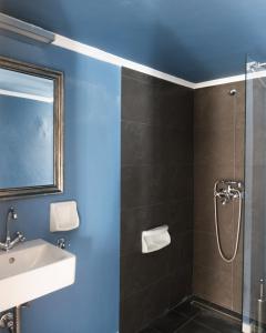 a bathroom with a sink and a shower at The Belgian Connection in Koukaki in Athens