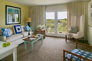 a living room with a couch and a table at Winnetu Oceanside Resort at South Beach in Edgartown