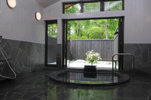 a bathroom with a large window and a round sink at Log Cottage Epoch in Hakuba +40 photos