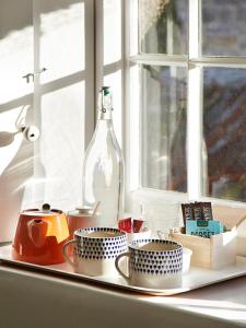 a shelf with cups and a bottle on a window at Compasses Inn in Tisbury