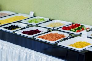 
a table topped with lots of different types of food at IT Time Hotel in Minsk
