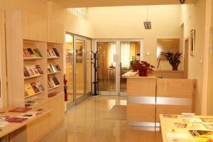 a room with a library with a desk and bookshelves at Saint Ignatius Retreat House in Ljubljana