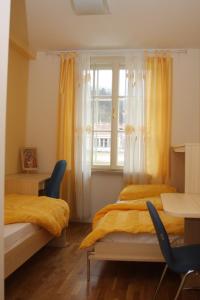 a bedroom with two beds and a window at Saint Ignatius Retreat House in Ljubljana