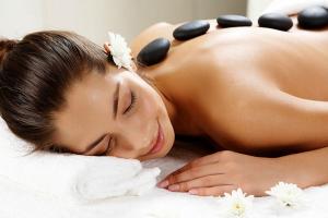 a woman laying on a towel in a spa treatment room at Wellness Pension Iveta in Žacléř +176 photos