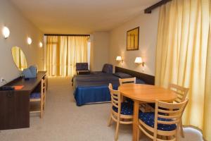 a hotel room with a bed and a table and a bedroom at Carina Beach in Sunny Beach