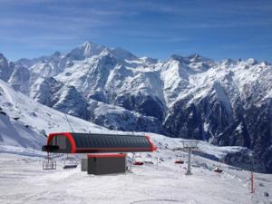 a ski lift on top of a snow covered mountain at Chalet Ramona in Grächen