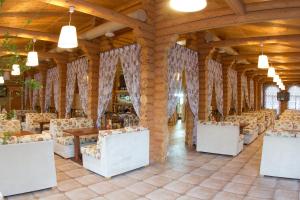 a banquet hall with chairs and tables in a building at Hotel White beach All Inclusive in Anapa