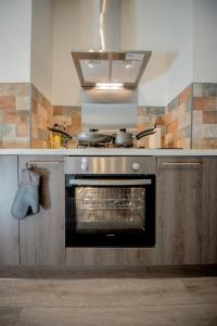 a kitchen with a stove with two pots and pans at Barnston House - Heswall - spacious homely holiday home by Rework Accommodation in Heswall