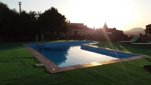 a swimming pool in the middle of a yard at AGRITURISMO SA è PADEDDA in Mores