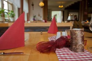 a table with red napkins and red flags on it at Haus am Mühlberg in Modautal