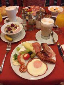 a table with a plate of breakfast foods and drinks at Hotel zum Heiligen Geist in Mariazell