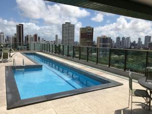 a swimming pool on the roof of a building at Flat Gildo Vilaça in Recife
