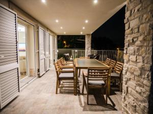 a table and chairs on a patio at night at Villa Carmen in Opatija