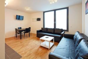 a living room with a couch and a table at City Apartment Stuttgart in Stuttgart