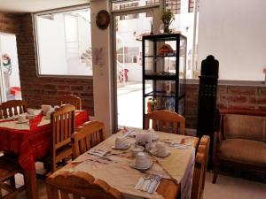 a dining room with tables and chairs and a window at Heritage Inn in Quito