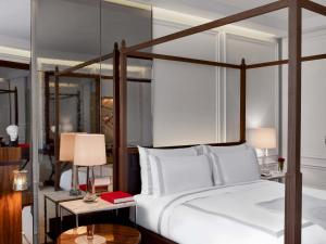 a bedroom with a large bed and two tables with lamps at Baccarat Hotel and Residences New York in New York