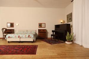 a bedroom with a bed and a piano at B&B Alle Querce in San Giovanni Rotondo