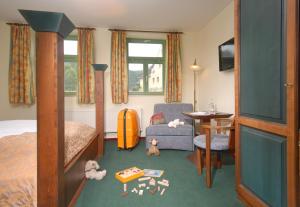 1 dormitorio con 1 cama, 1 silla y 1 mesa en Hotel Saigerhütte, en Olbernhau