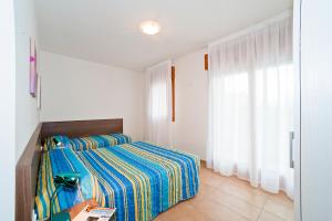 Postel nebo postele na pokoji v ubytování Residence Galleria Gran Madò