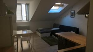 a living room with a couch and a table at Rent4night Grenoble Europole in Grenoble