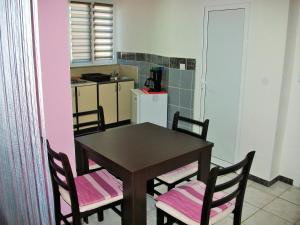 a kitchen with a table and chairs in a room at Apartments Petrovic in Krimovice