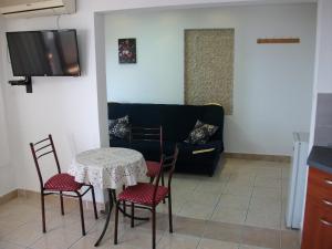a living room with a table and chairs and a couch at Apartments Petrovic in Krimovice