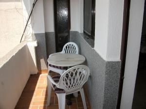 a small table and two chairs on a balcony at Apartments Petrovic in Krimovice