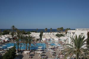 an aerial view of a resort with a pool and palm trees at El Mouradi Club Kantaoui in Port El Kantaoui